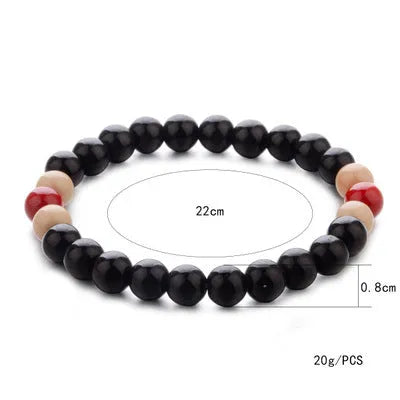 Unisex ethnic-style beaded bracelet made from natural lava stone on a wrist.