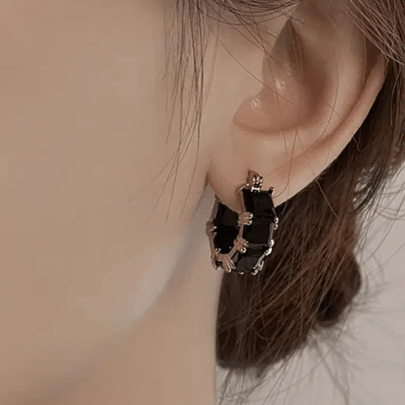 Geometric U-shaped ear rings with crystal zircon accents in black, pink, or white options
