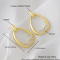 Yellow gold geometric drop earrings with oval and round ring elements on copper