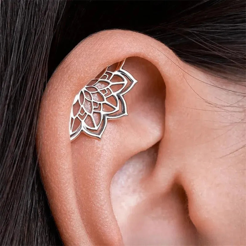 Spider web design metal stud earrings in gold or silver electroplated finish.