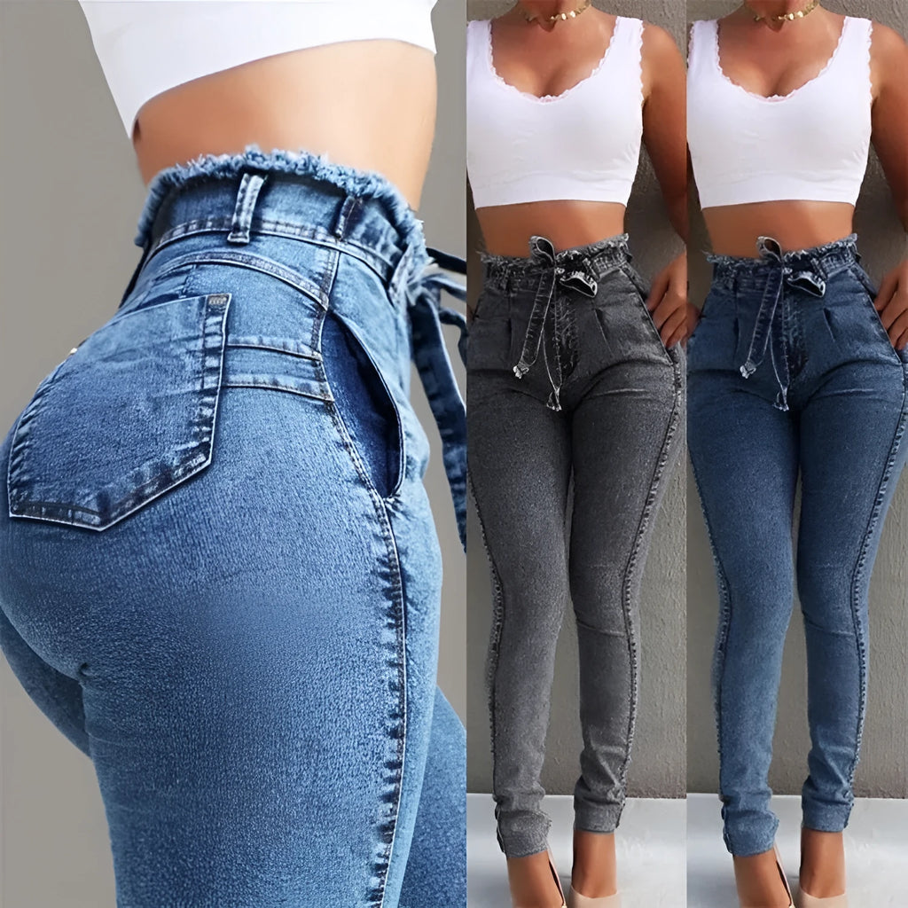 Women's fringed jeans in cowboy denim fabric showing decorative leg fringing detail