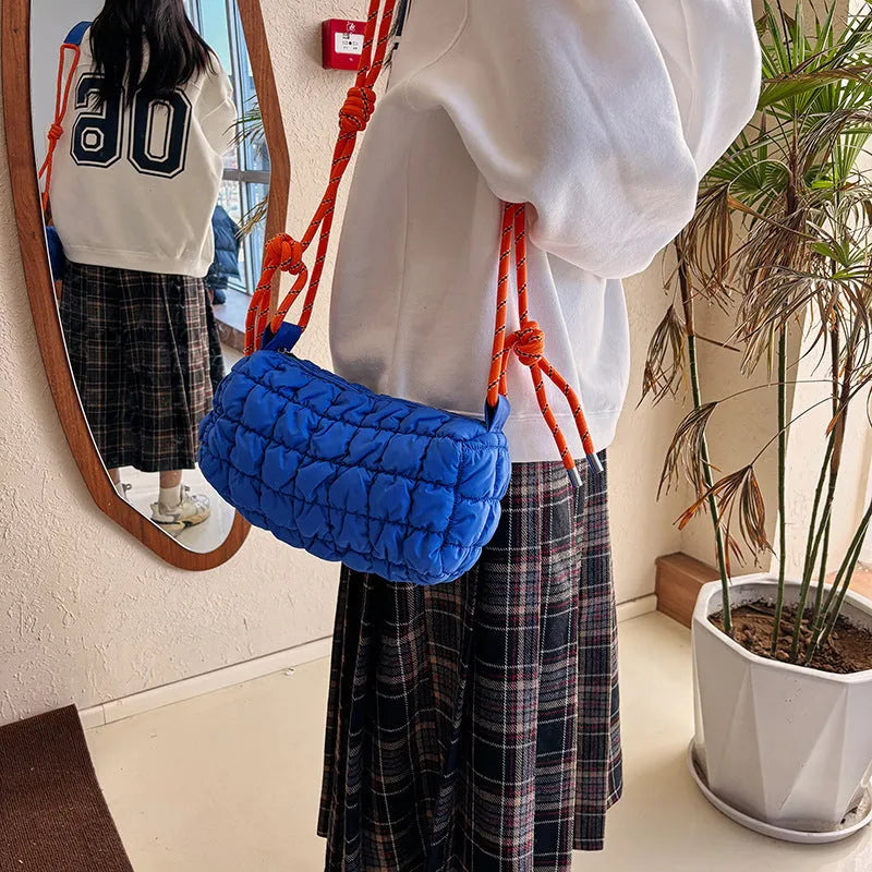 Soft pillow-shaped nylon messenger bag in multiple colours with a single shoulder strap.