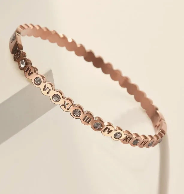 Korean style titanium steel bracelet with a numeric charm, shown in gold, rose gold, and steel colour options.