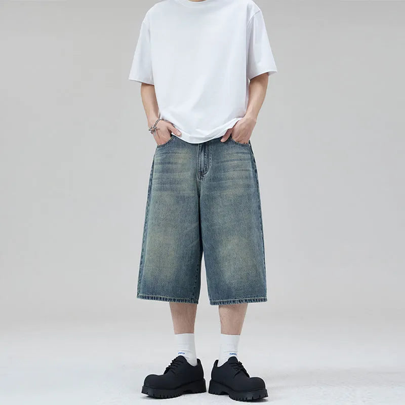 Men's loose straight-leg denim shorts in light blue on a model for summer