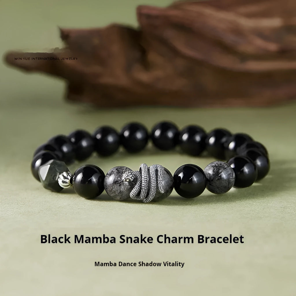 Men's obsidian black snake bracelet made of sterling silver with retro zodiac styling on a wrist.