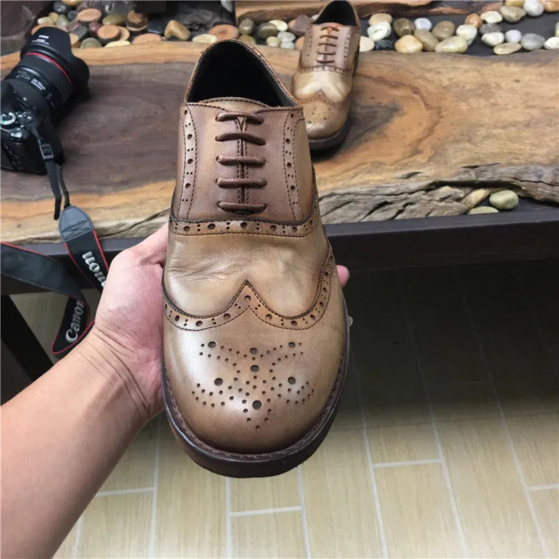 Light brown men's vintage distressed leather shoes with engraved detailing, round toe, and lace-up front.