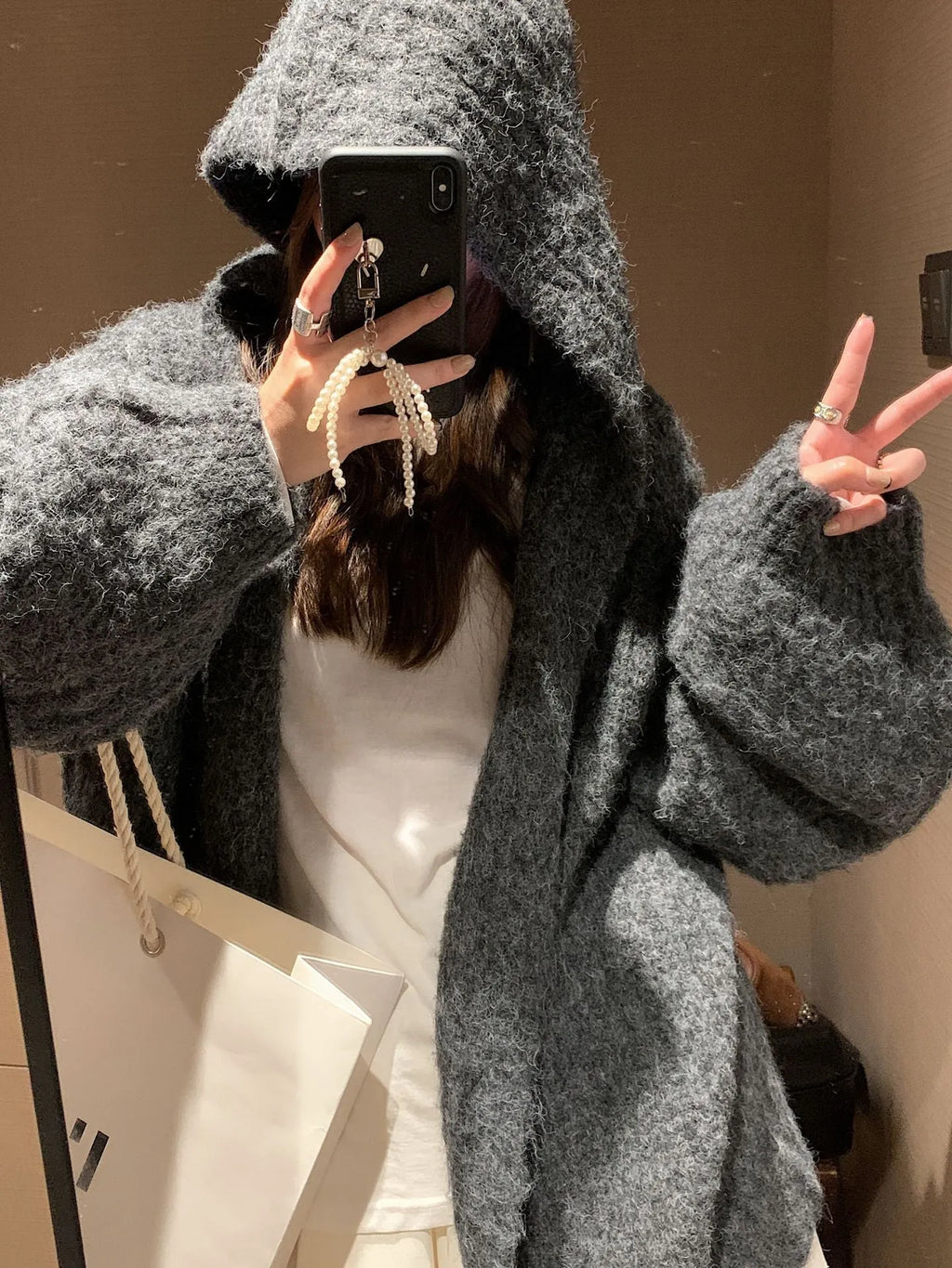 Women's dark grey retro Maillard knit hooded cardigan on a hanger, showing loose fit and regular sleeves.
