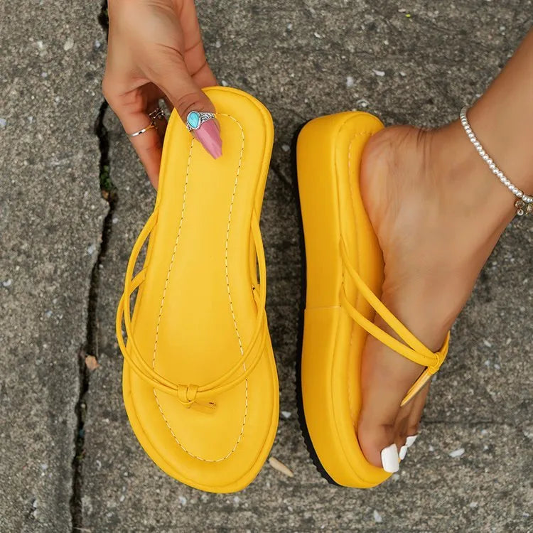 Thick-soled herringbone pattern flip-flops in multiple colours on a white background