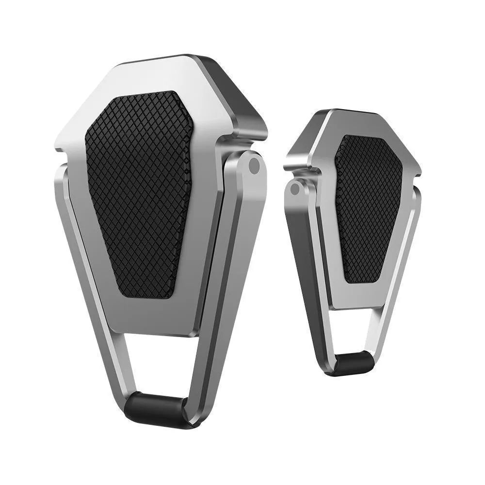 Compact silver aluminium folding laptop stand on a desk next to a wireless keyboard.