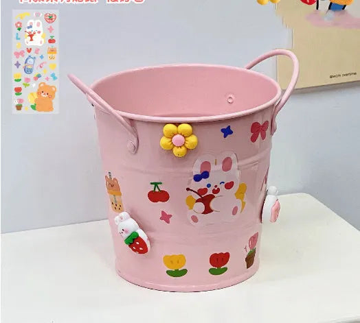 Round metal desktop pen holder in a choice of colours, some with decorative sticker patches.