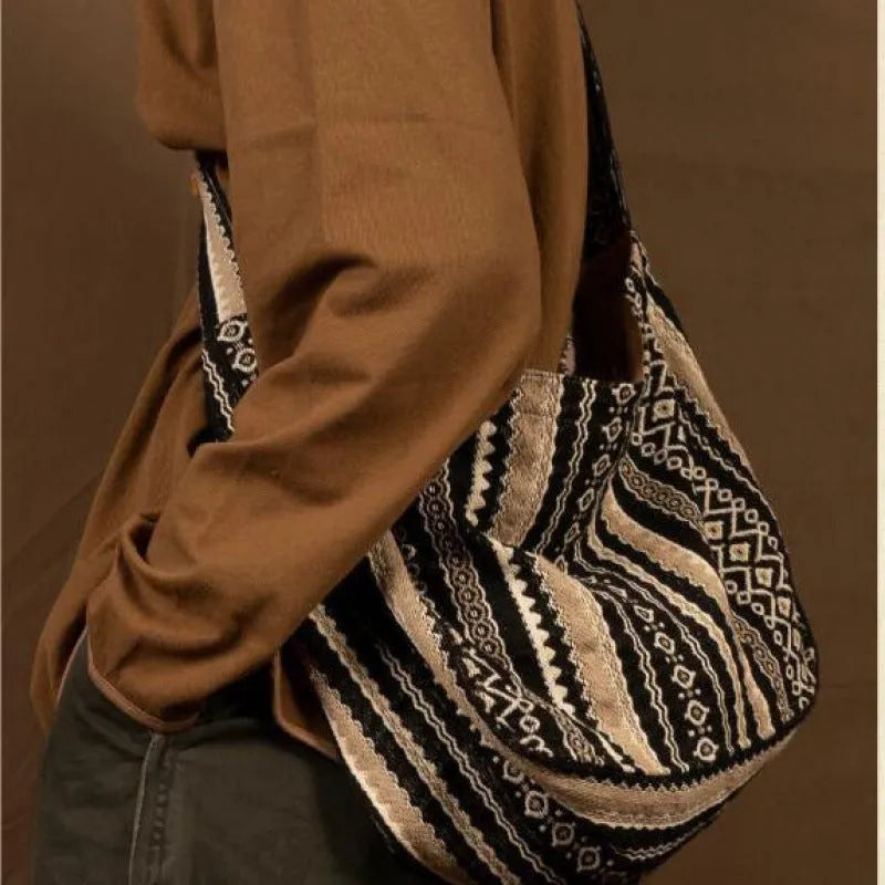 Retro striped corduroy messenger bag with adjustable plaid shoulder strap and zipper closure