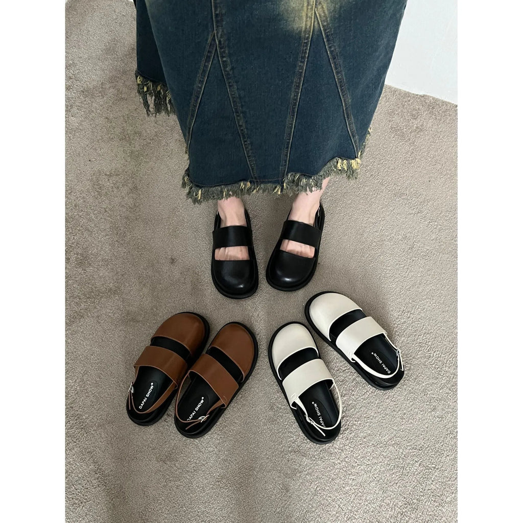 Retro style closed toe sandals with a single ankle buckle strap in apricot colour.