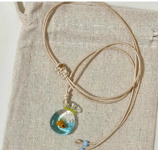 Women's necklace with coloured glaze joker charm on cotton linen chain in small fish lucky bag colour