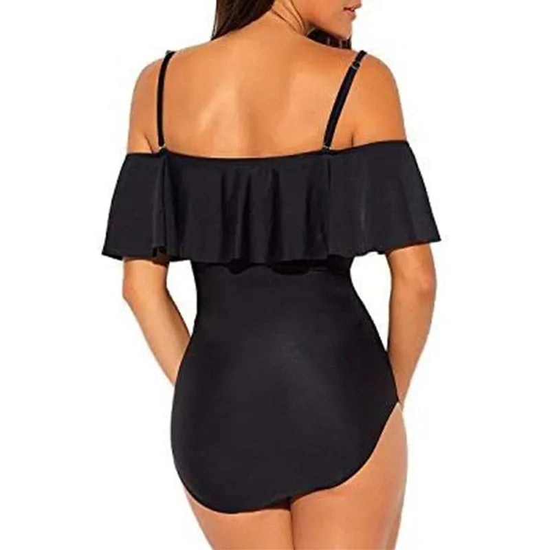 Black one-piece swimsuit with cut-out detail and ruffled straps on a tube top.