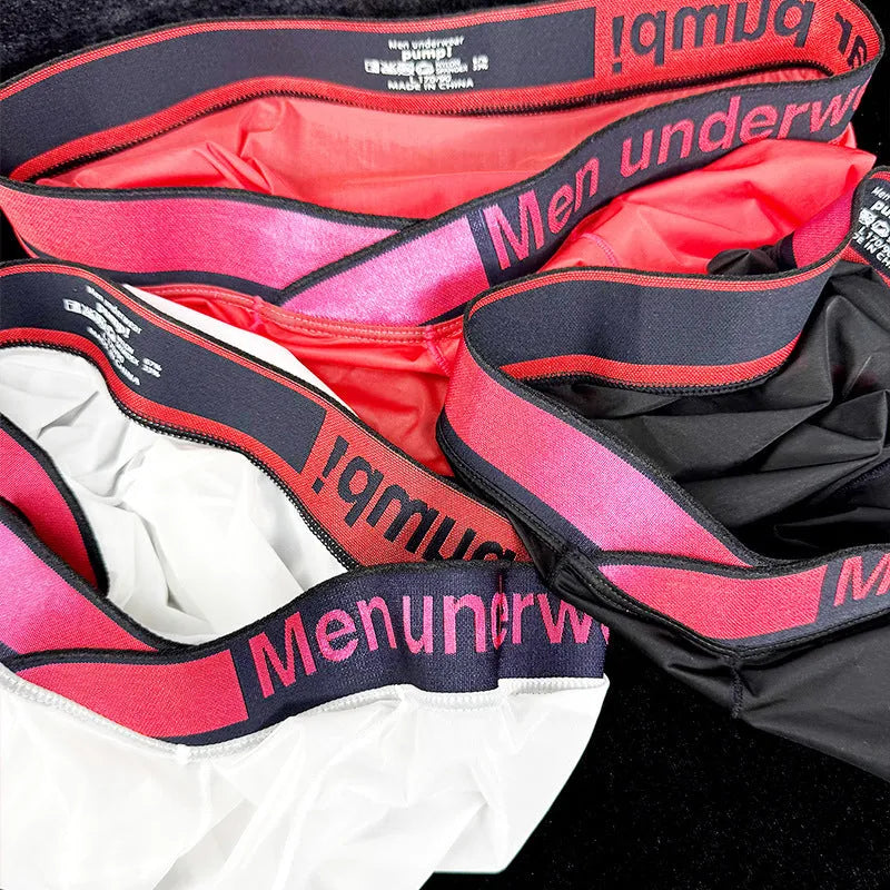 Men's black low waist seamless underwear with a red gradient laser print design on the front