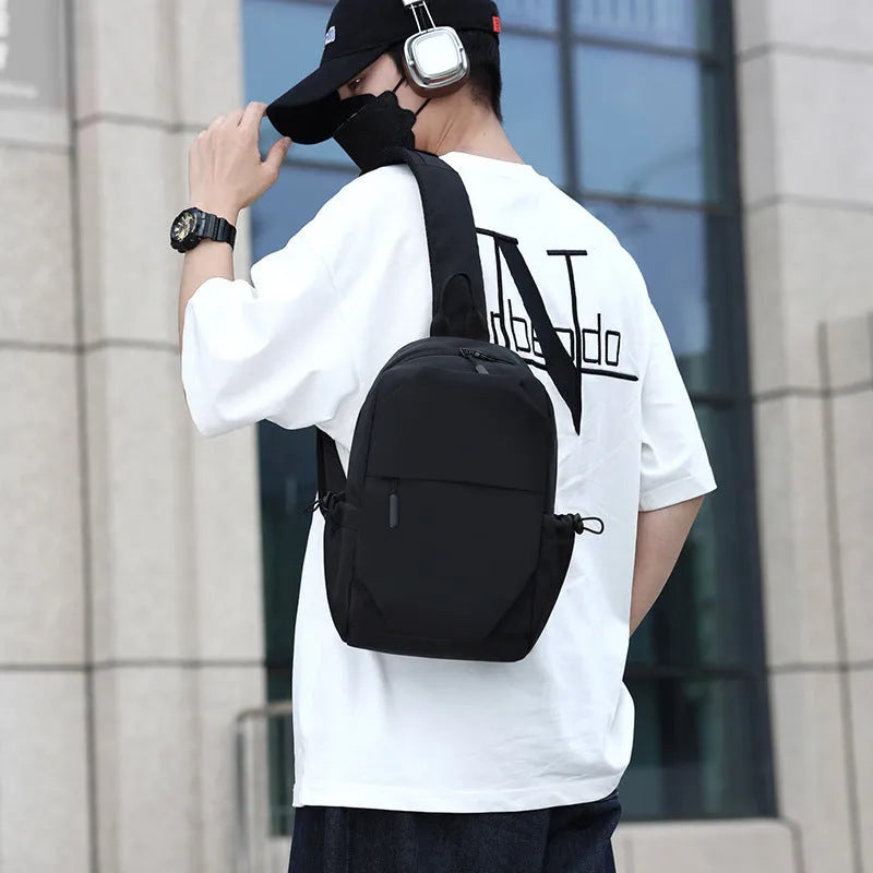 Men's grey waterproof chest bag with shoulder strap showing 33cm height dimensions