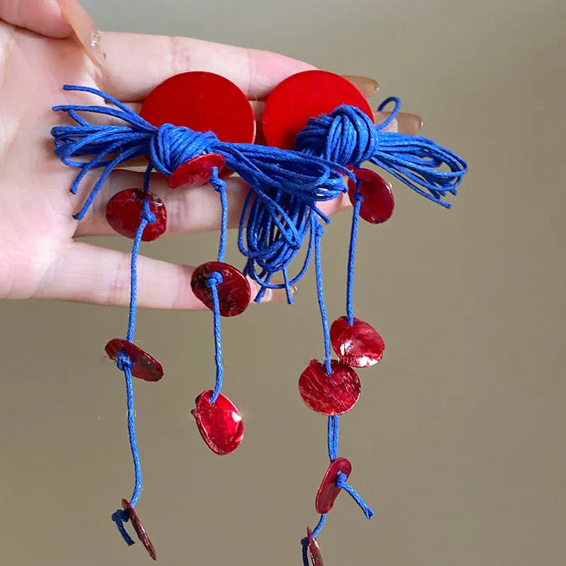 Blue geometric earrings with resin flower detailing and cloth material construction