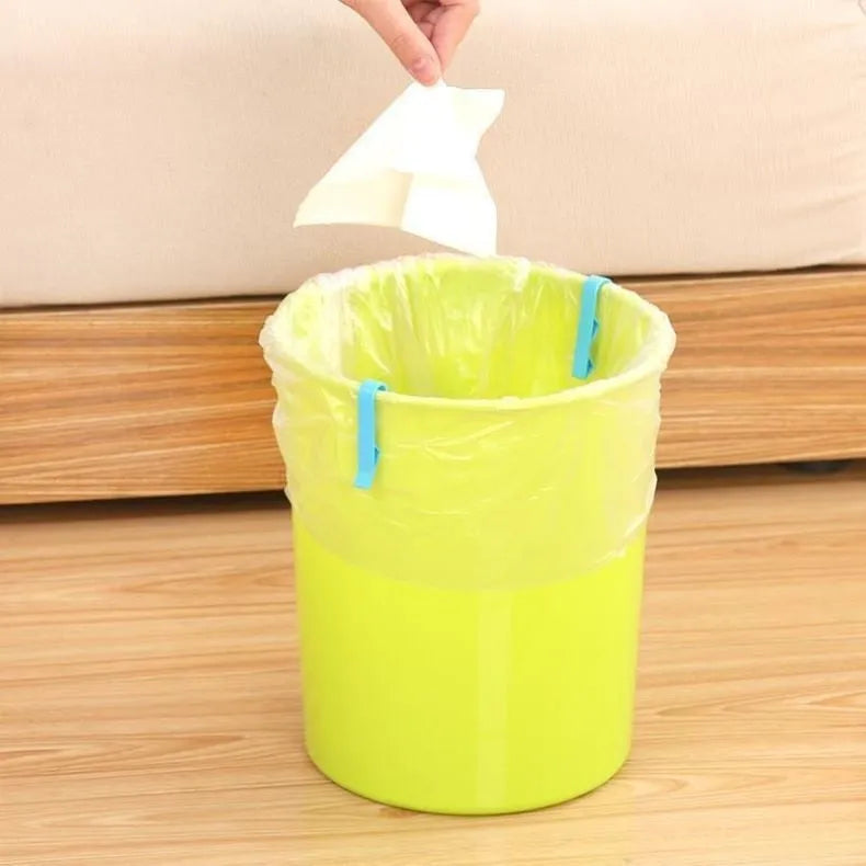White PP plastic garbage bag fixing clip holding a black bin liner to a trash can rim.