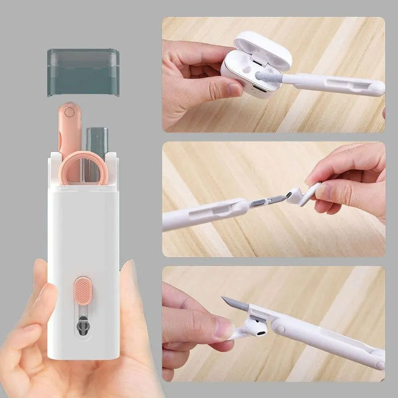 White cleaning set with pen, brush, keycap puller, and spray bottle on desk