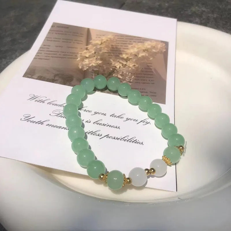 Handmade Chinese style glass bracelet with bamboo joint beads in a red Lvzhu Duobao design.