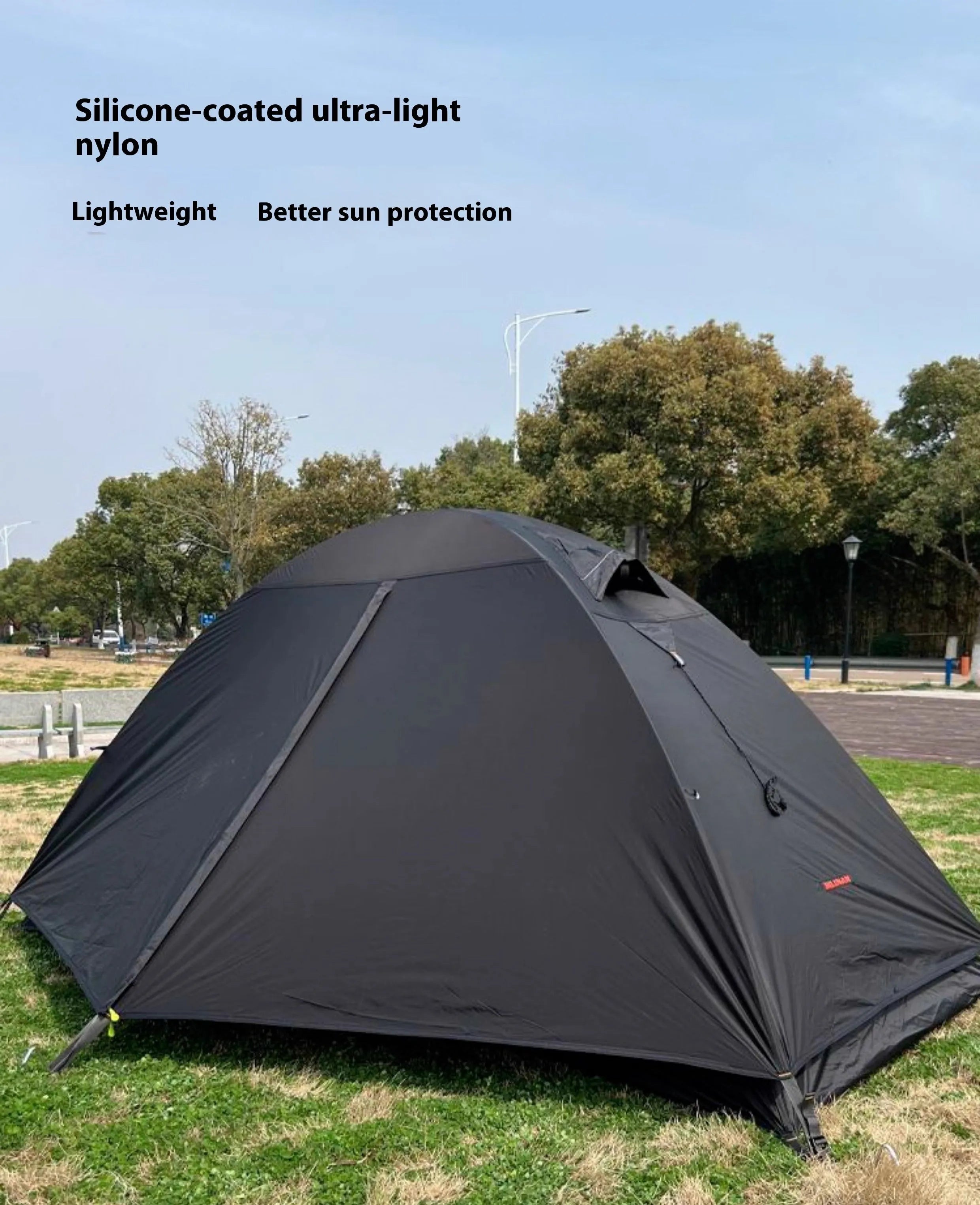 Single person backpacking tent with aluminium poles shown in a red colour option, pitched outdoors.