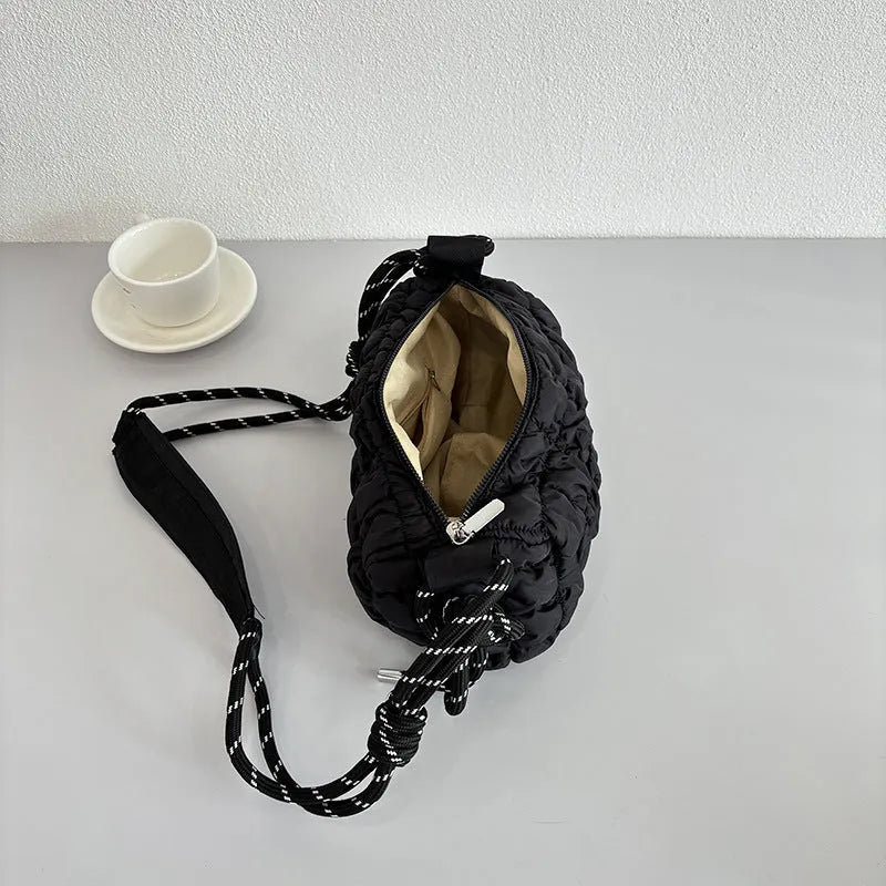 Soft pillow-shaped nylon messenger bag in multiple colours with a single shoulder strap.
