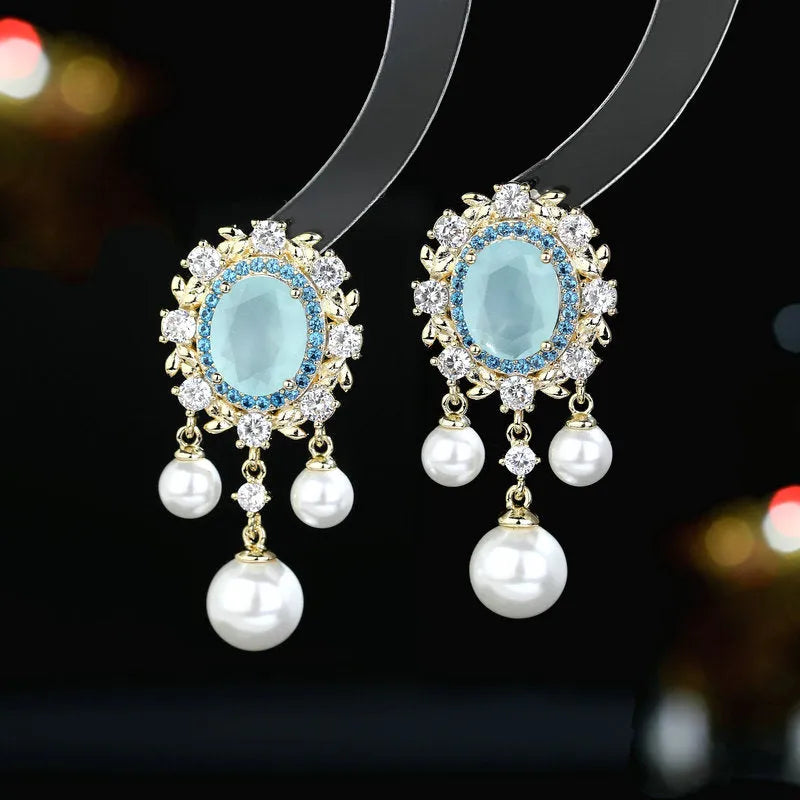 Oval geometric copper drop earrings with pearl elements, inlaid zircon treatment, and tassel detailing in light purple colour