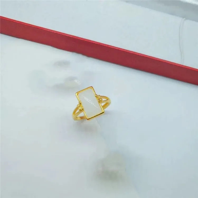 Adjustable brass gold-plated ring with gemstone in green, white or black options showing adjustable port mechanism