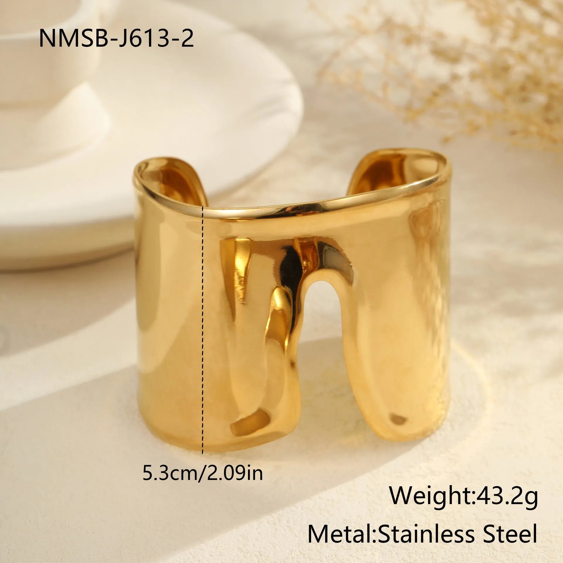 Women's wide cuff bracelet with gold plating and exaggerated niche opening in asymmetric wave design