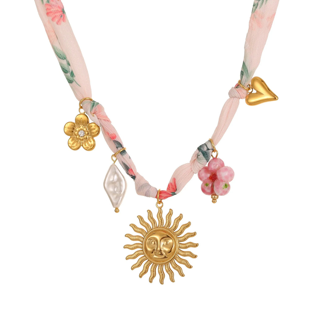 Gold-plated stainless steel necklace showing geometric sun pendant on an adjustable chain.
