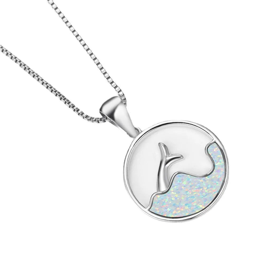 White gold geometric fishtail necklace with a round blue opal pendant on an adjustable chain.