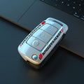 White and carbon coloured car key holders with a carbon fibre texture and mirror surface.