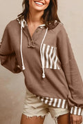 Straw yellow hoodie with waffle texture fabric, striped patchwork design, and button neck closure.