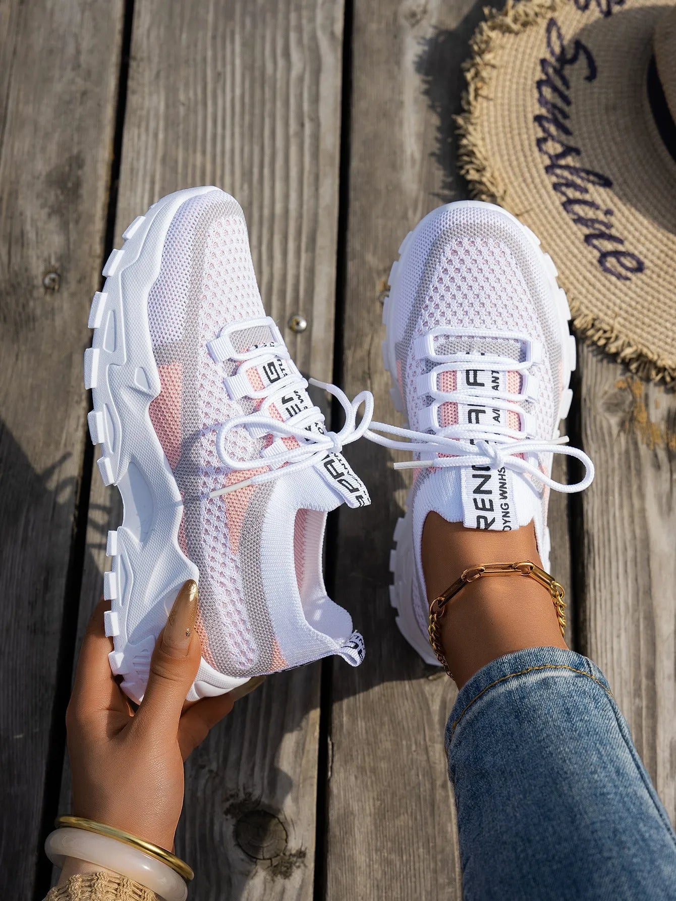 Women's Flyknit mesh lace-up sneaker in a grey colourway, showing the breathable upper and rubber sole.