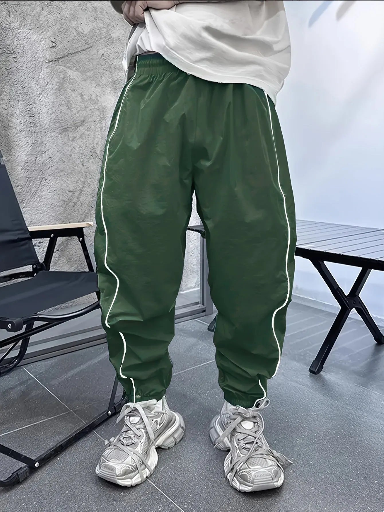 Men's loose blue bamboo fibre cropped sports trousers on a grey background