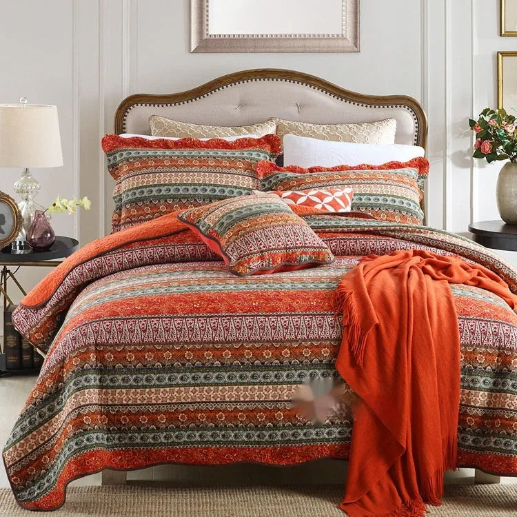 Quilted pure cotton bed cover set with printed pattern on a bed, includes two matching pillowcases.
