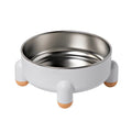 Green stainless steel pet bowl with non-slip base and high foot design on a wooden floor
