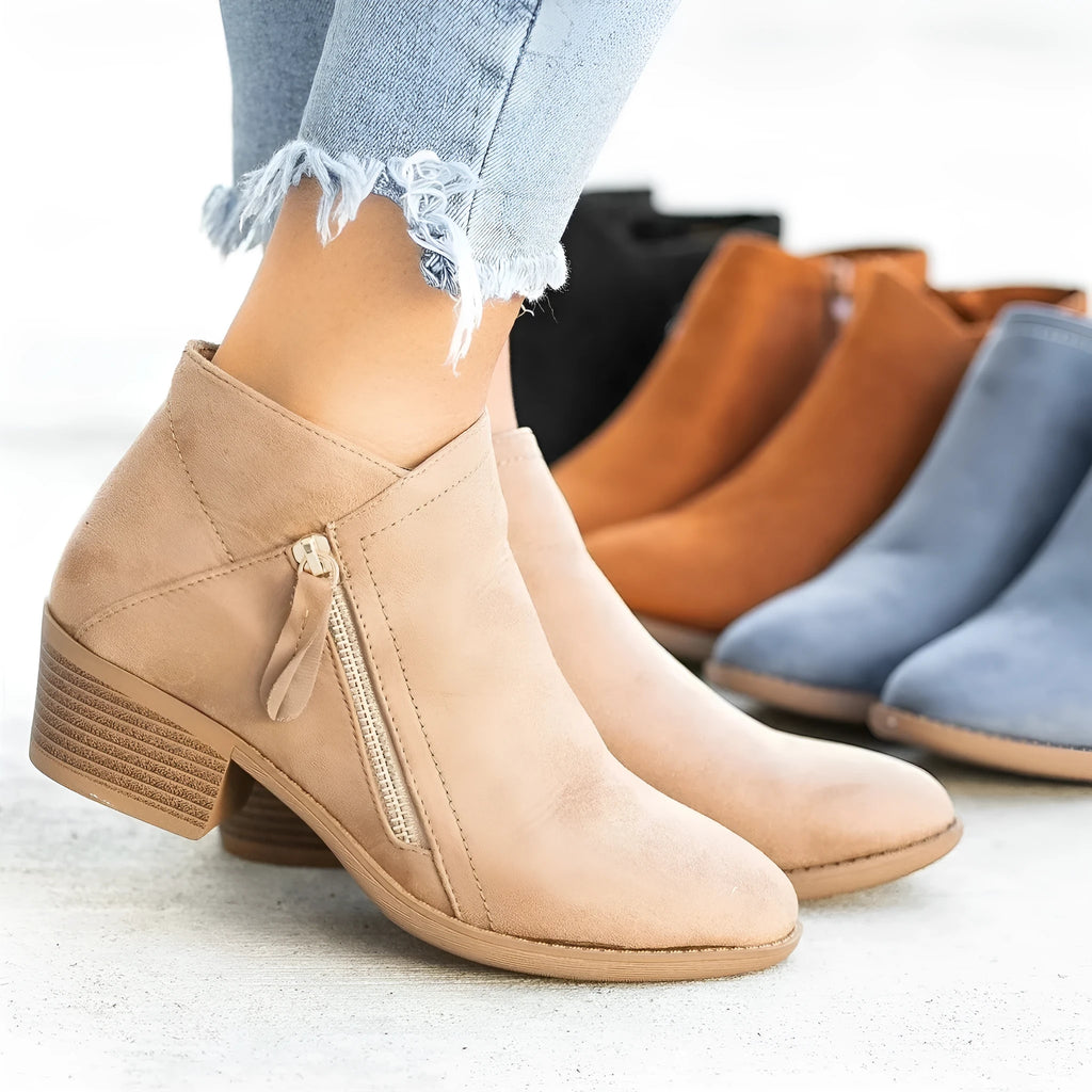 Women's blue suede ankle boot with chunky heel and side zip, on a white background.