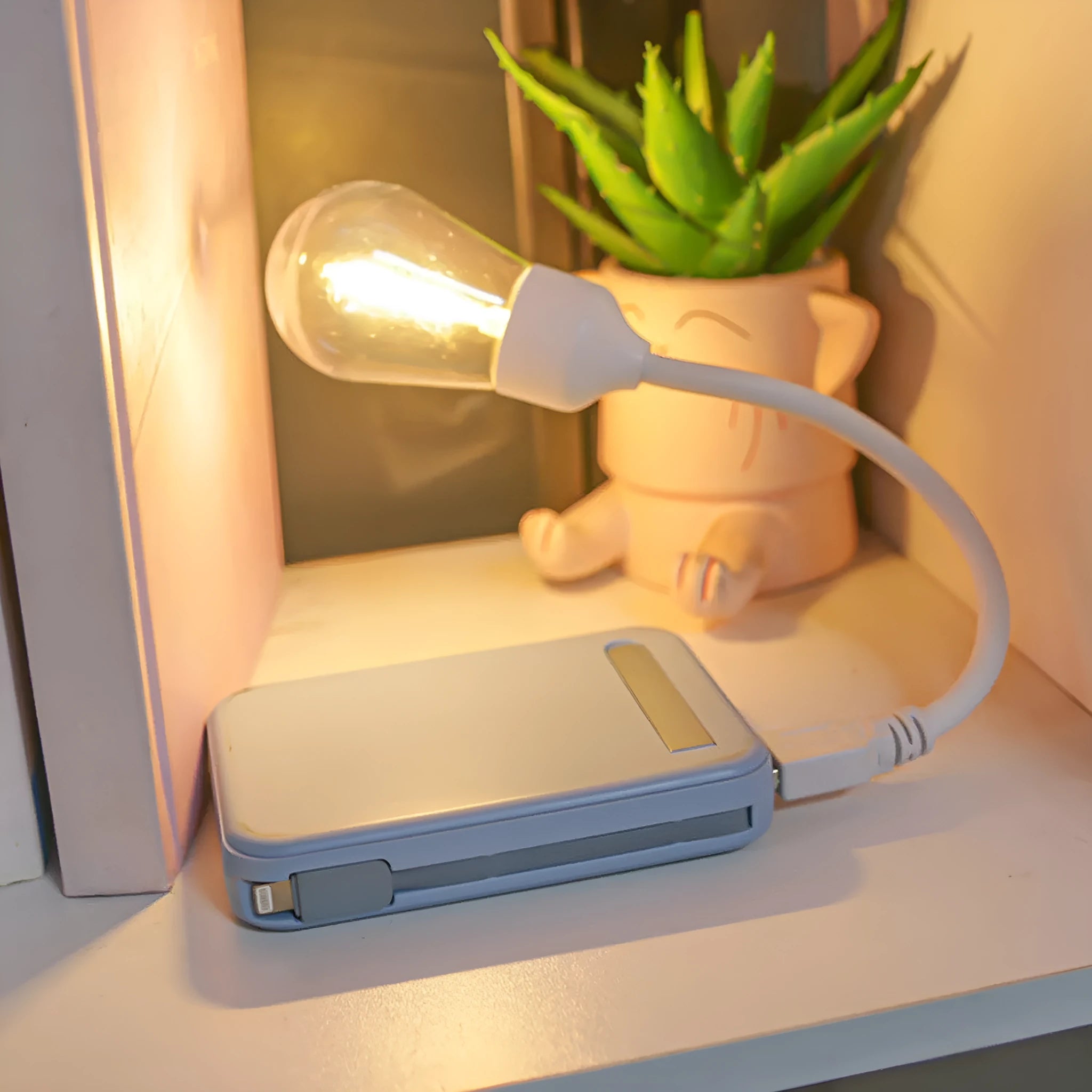 A folding USB rechargeable night light with a glowing tungsten filament S14 LED bulb.