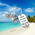 Stainless steel key ring with detailed motorcycle design on metal surface