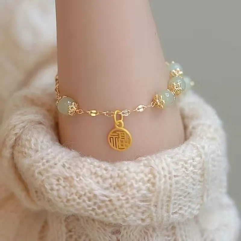 Handmade Chinese style glass bracelet with bamboo joint beads in a red Lvzhu Duobao design.