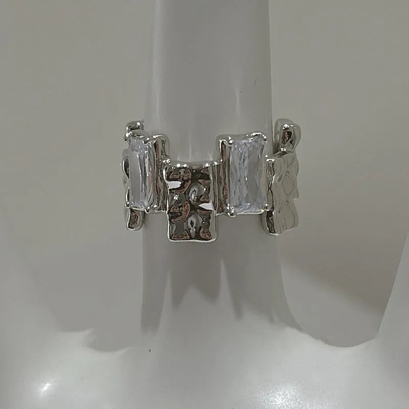 Silver geometric cross ring with open zircon gemstone design and three-dimensional decoration