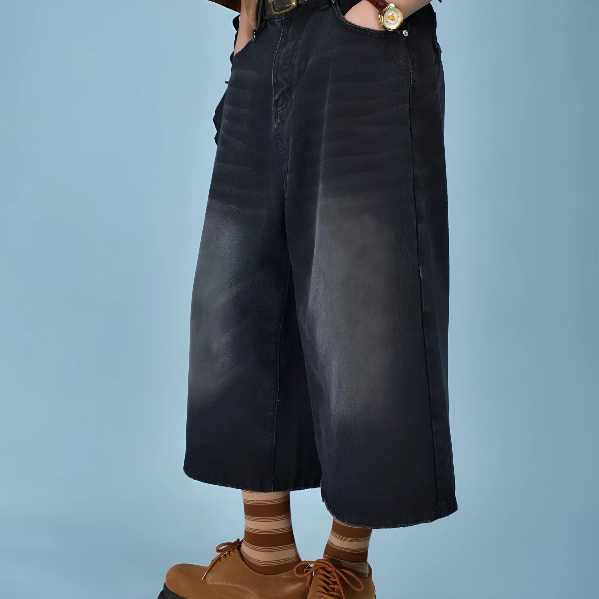 Men's loose straight-cut denim shorts in blue, shown on a hanger.