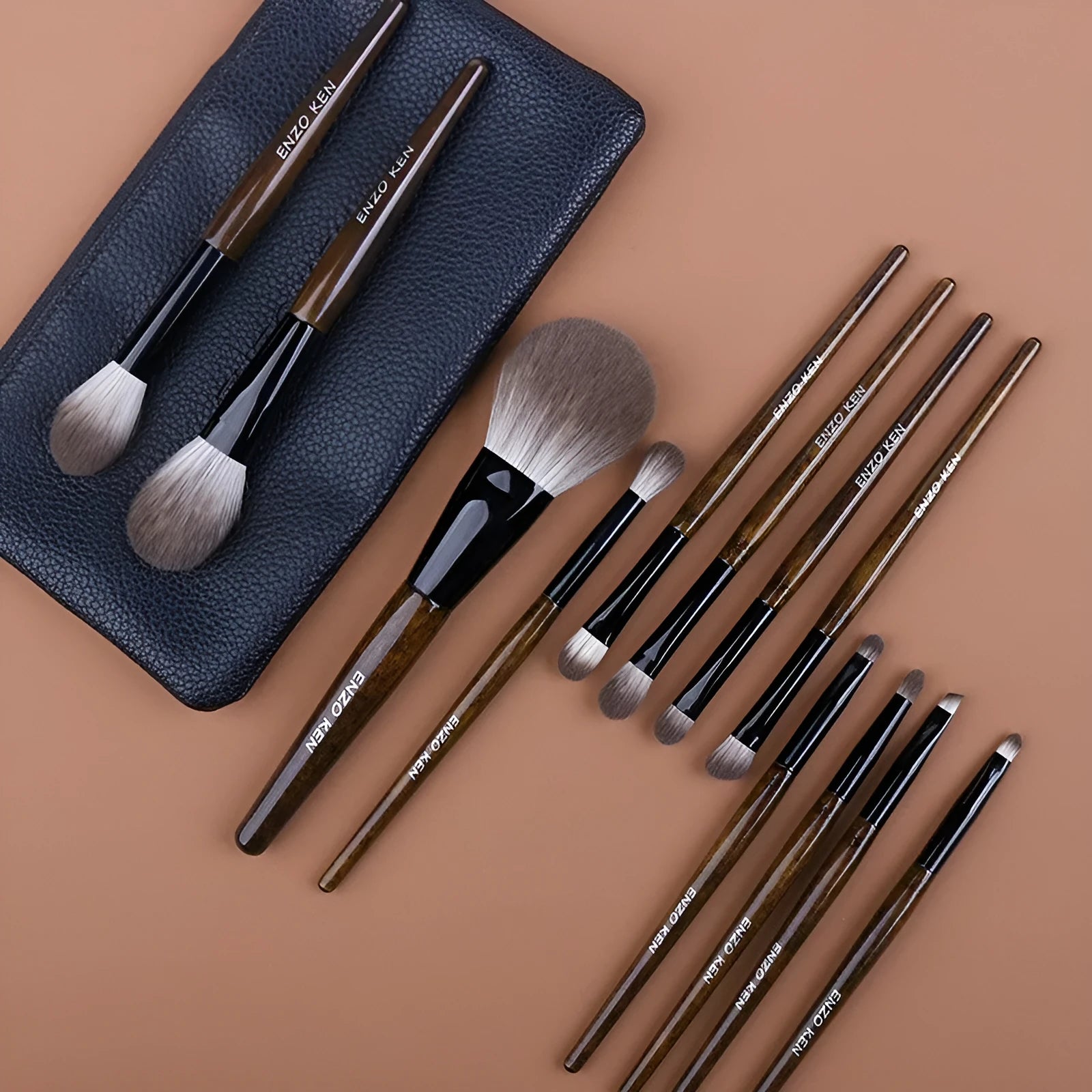12-piece makeup brush set with wooden handles and a black PU storage pouch laid out.