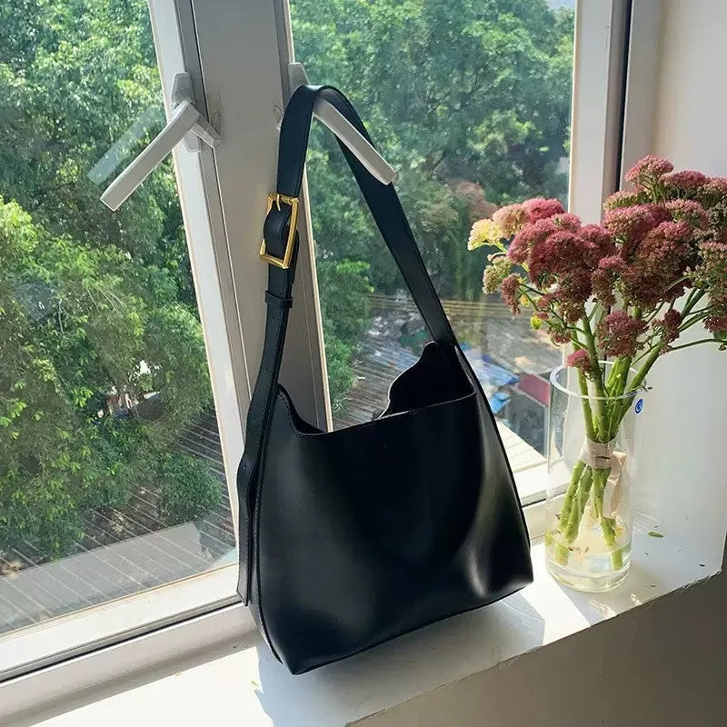 Women's soft PU leather shoulder bag with decorative threads measuring 28x32x12cm in black and brown colour options