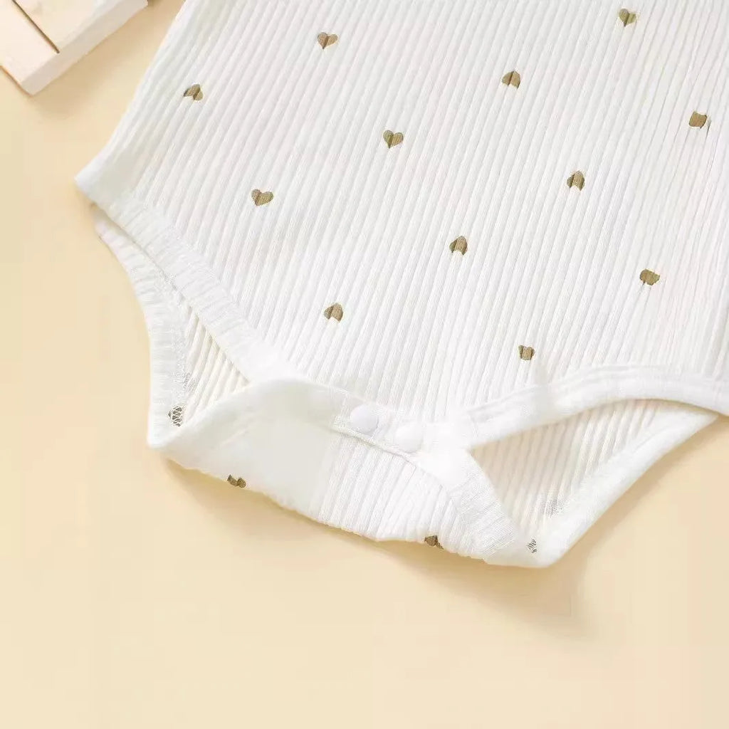 White cotton baby suit three-piece set with top, long pants, and hair tie showing sunken stripe stitching
