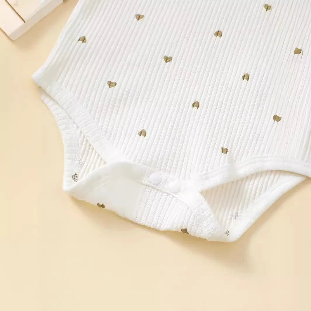 White cotton baby suit three-piece set with top, long pants, and hair tie showing sunken stripe stitching
