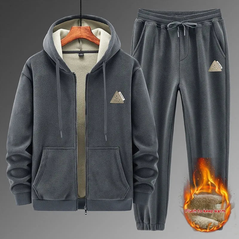 Man wearing a grey hooded sweater and matching trousers from a men's two-piece casual sports suit set.