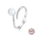 Adjustable sterling silver ring with natural shell pearls and open loop design