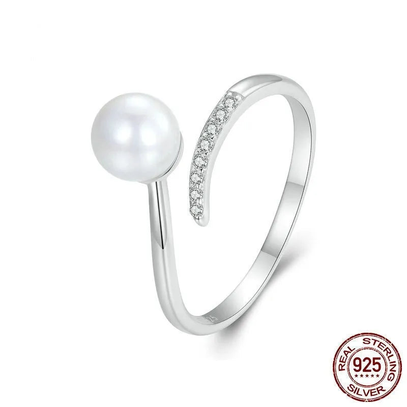 Adjustable sterling silver ring with natural shell pearls and open loop design